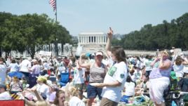 Tens of thousands of young people on the National Mall celebrate the 100th anniversary of Girl Scouts of the United States